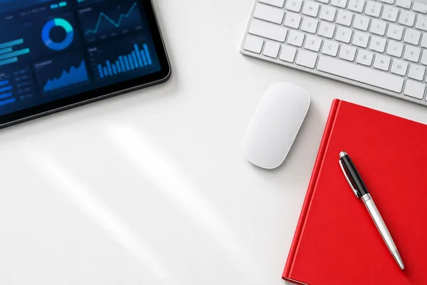 A bright, tidy workspace with analytics on a tablet — ready to plan smart technology solutions